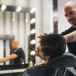 Bearded Man Getting Beard Haircut With A Razor By Barber